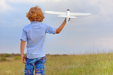 Image showing Boy with toy plane