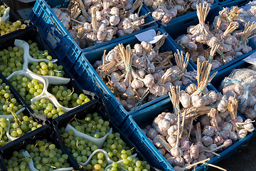 Image showing fresh garlic and grapes in a market