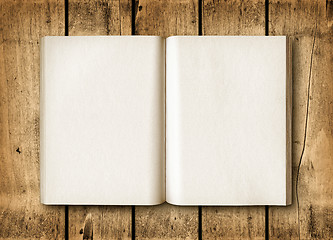 Image showing Open book on a brown wood table