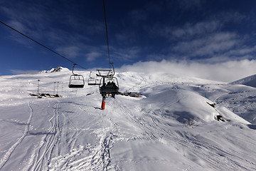 Image showing Chair-lift and off-piste slope in sun day