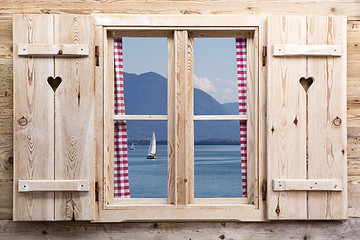 Image showing Wooden window with a lake as reflections