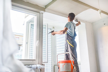 Image showing Plasterer renovating indoor walls and ceilings.