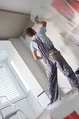 Image showing Plasterer renovating indoor walls and ceilings.