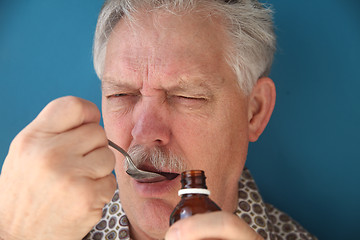 Image showing taking bitter medicine