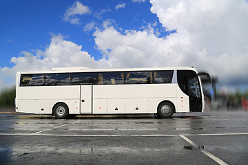 Image showing White Coach Bus Waits for Passengers on Foggy Rainy Morning