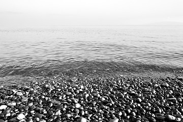 Image showing stone in the coastline sunrise and light ocean white sky