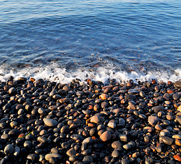 Image showing stone in the coastline sunrise and light ocean white sky