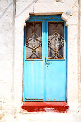 Image showing blue door in antique village santorin   white wall