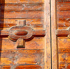 Image showing grain texture of a brown antique wooden old door in italy   euro