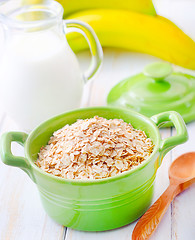 Image showing Oat flakes in the green bowl with banana and milk