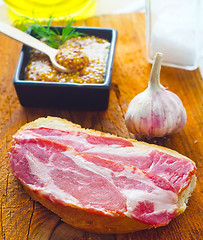 Image showing Bread with bacon on the wooden board