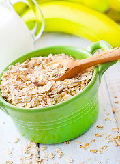 Image showing Oat flakes in the green bowl with banana and milk