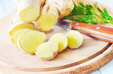 Image showing Fresh ginger and knife on the wooden board