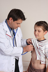 Image showing Doctor examining a child