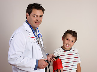 Image showing Doctor checking blood pressure