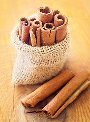 Image showing Aroma cinnamon sticks on the wooden board