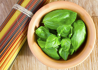 Image showing fresh basil and raw pasta