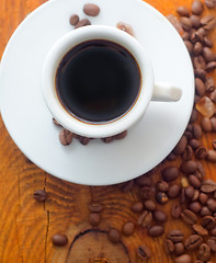 Image showing Fresh aroma coffee in the white cup, coffee and cinnamon