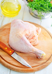 Image showing Raw chicken and knife on the wooden board