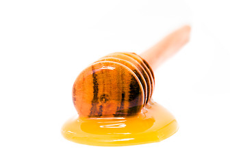 Image showing honey on a stick on a white background