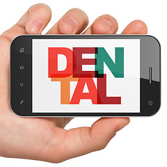 Image showing Medicine concept: Hand Holding Smartphone with Dental on  display