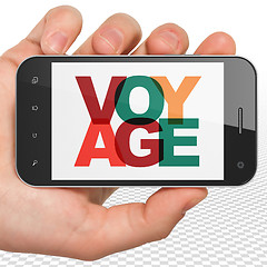 Image showing Tourism concept: Hand Holding Smartphone with Voyage on  display