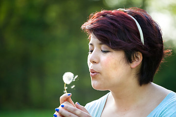 Image showing Woman Blowing Dandelion