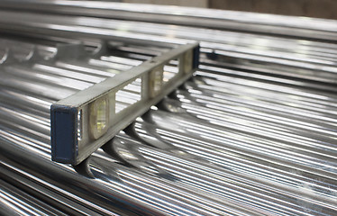 Image showing Level on a stack of steel tubes