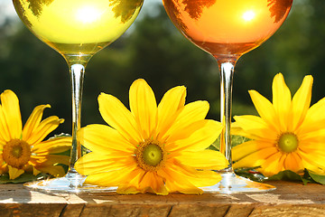 Image showing Golden wine in the sun on a rustic table