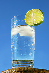 Image showing Cold glass of water against a blue sky