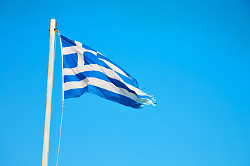 Image showing waving   flag in   blue sky and flagpole