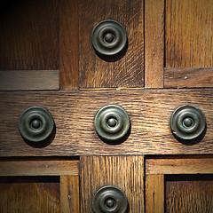 Image showing in london antique brown door  rusty  brass nail and light