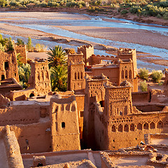 Image showing sunset in africa old construction near the river blue