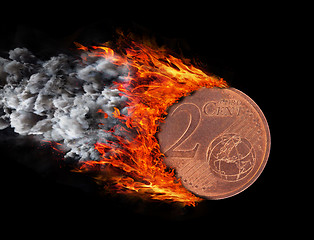 Image showing Burning coin with a trail of fire and smoke