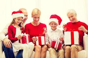 Image showing smiling family with gifts at home