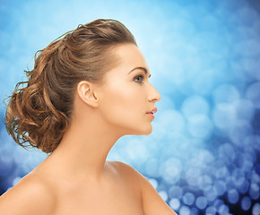 Image showing beautiful young woman face over blue background