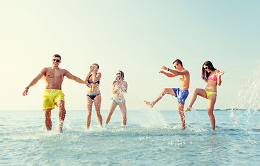 Image showing happy friends having fun on summer beach