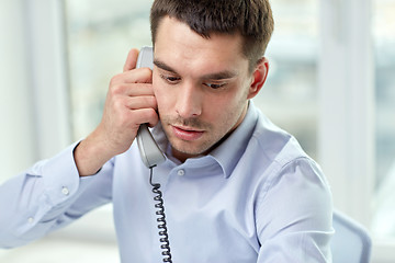 Image showing face of businessman calling on phone in office