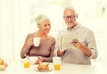 Image showing happy senior couple having breakfast at home