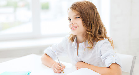 Image showing student girl writing in notebook at school