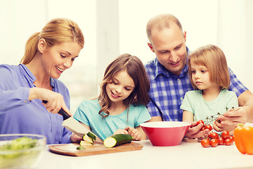 Image showing happy family with two kids making dinner at home