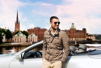 Image showing man near cabriolet car over city of stockholm