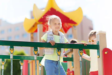 Image showing happy little girl climbing on children playground