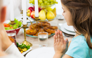 Image showing close up of girl praying at holiday dinner