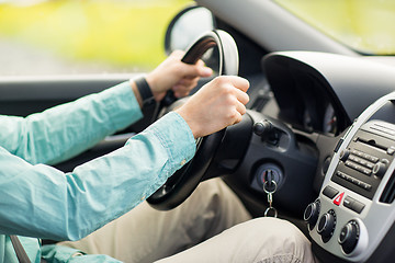 Image showing close up of young man driving car