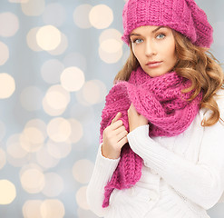 Image showing woman in hat and scarf over lights background