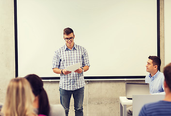 Image showing group of smiling students and teacher in classroom