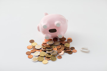 Image showing close up of euro coins and piggy bank on table