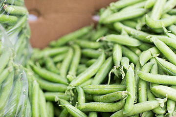 Image showing close up of green peas in box at street market