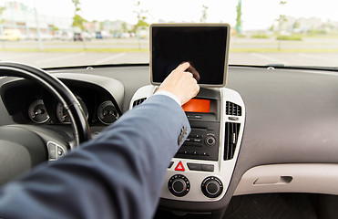 Image showing close up of young man with tablet pc driving car